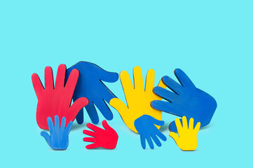 Colorfull puzzles hands on blue background. World Autism Awareness Day Concept