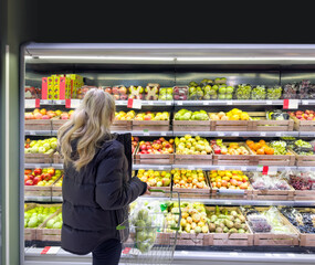 Woman buying fruits and vegetables at the market