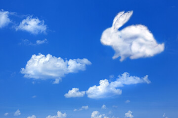 fluffy cloud Easter bunny on a cloudy sky blue background,