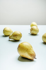 A few ripe pears on surface of a smooth subtle blue color
