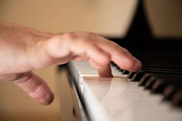 Fototapeta na wymiar Closeup on fingers on a piano
