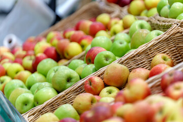 Apples on the shelves of a grocery store. Sale of fresh fruit. Selective focus