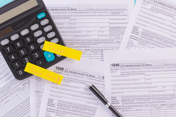 Tax fill concept with "Need Help" word, pen and calculator  with 1040 U.S. form backgound