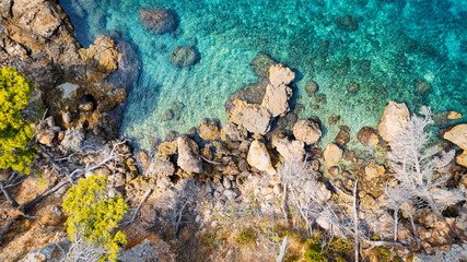 The stunning beauty of Croatia's rocks and forests is captured in this breathtaking aerial view. Take in the turquoise waters and beach from above, and add this travel image to your collection of unfo