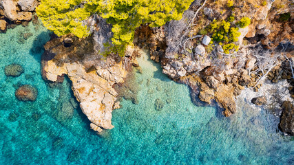 The stunning beauty of Croatia's rocks and forests is captured in this breathtaking aerial view. Take in the turquoise waters and beach from above, and add this travel image to your collection of unfo