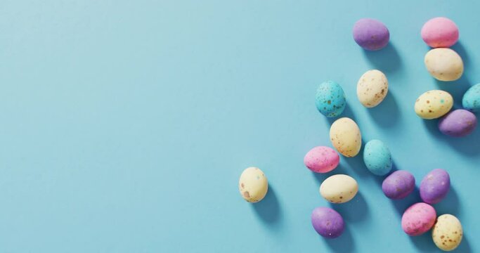 Video of decorated colorful easter eggs on a blue surface