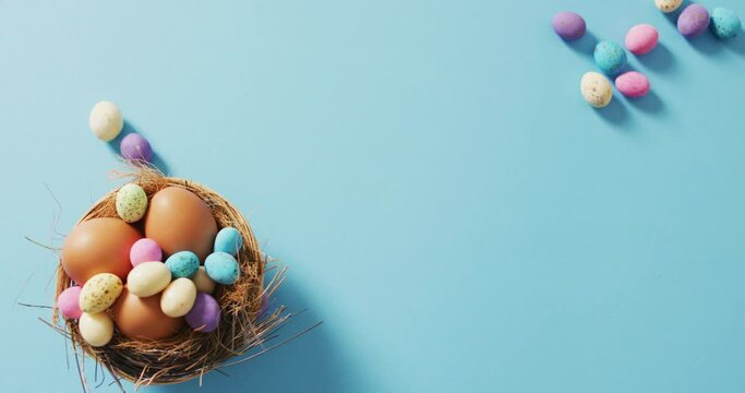 Video of decorated colorful easter eggs on a blue surface