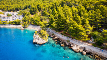 Enjoy the view of Croatia's beach from above, where turquoise waters meet soft sands. Relax and find adventure in this beautiful vacation spot, captured in stunning aerial photography.