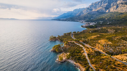 A drone captured the stunning aerial view of Croatia's coastal area, which features crystal-clear blue water and lush forests on land.