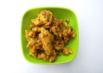 Besan pakora in a bowl on white background 