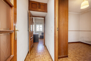 Distributor corridor of a house with glossy oak wood floors, access to other rooms with sapele wood doors and mezzanines of the same material - obrazy, fototapety, plakaty