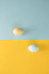 Eggs on a yellow and light blue background. Easter decor. Yellow and blue color