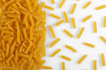 Pasta products in the form of a spiral, texture, on a white background - Powered by Adobe