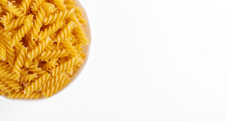 Pasta products in the form of a spiral on a plate, texture, on a white background
