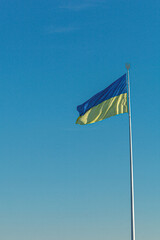 Ukrainian flag against the blue sky