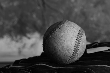 Old grunge baseball in black and white with vintage style background.