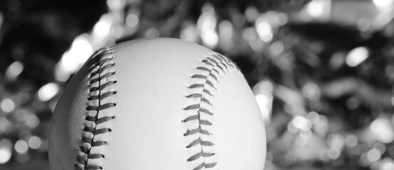 Baseball with fancy sparkle bokeh background in black and white with copy space for sport banner.
