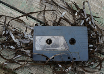 Old audio tape cassette on old wooden background