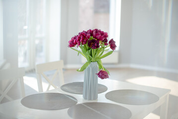 Home interior decor, bouquet of flowers in a vase on table in the kitchen