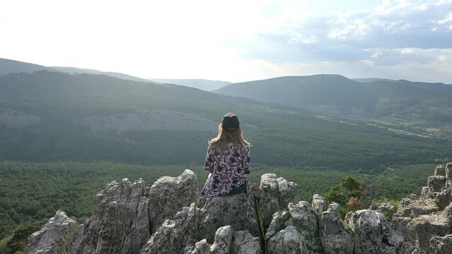 Woman observes the landscape of the Orihuela del Tremedal village in Teruel, Spain.
