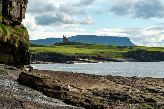 Distant view of Classiebawn castle at the coast of Mullaghmore Head, County Sligo, Ireland