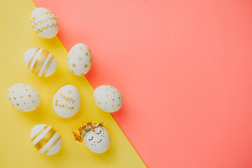 Easter background. Easter golden decorated eggs on mixed color background. Minimal easter concept. Flat Lay of Golden Easter Eggs