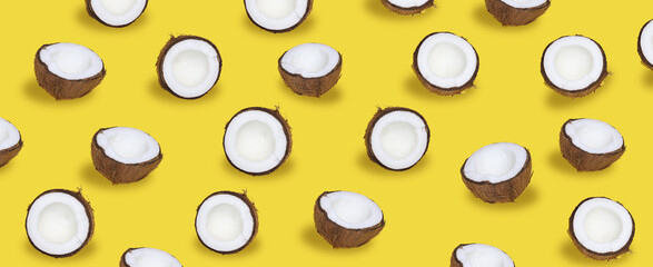 Exotic summer background, Repetition half Coconut in brown shell seamless pattern on a yellow bright background, top view. 