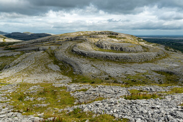 Iconic spiral shaped limestone rock formations of Slieve Rua hill, The Burren National Park, County...