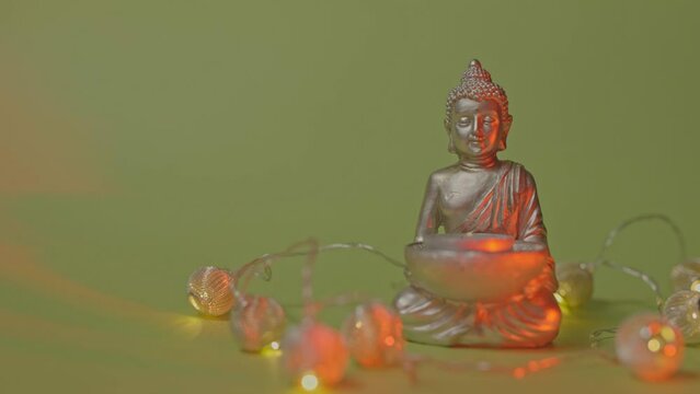 Candle holder with Buddha image