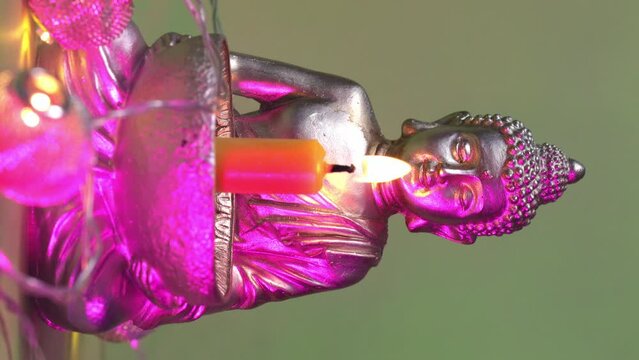 Candle holder with Buddha image. Vertical