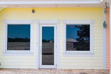 entrance of the yellow house. entrance of house outdoor. entrance of house outside.