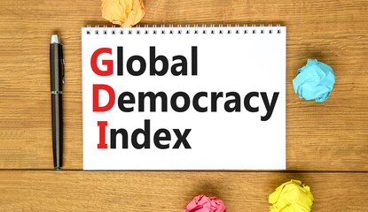 GDI global democracy index symbol. Concept words GDI global democracy index on white note on...
