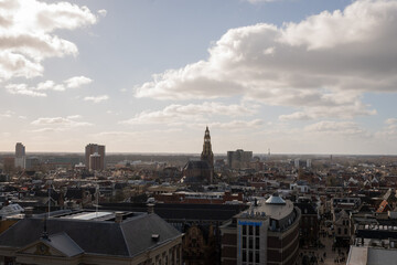 Groningen cityscape skyline with church spire breaking the horizon on a sunny clear day. The Akerk  gothic religious architecture is prominent against modern buildings