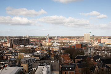Groningen cityscape skyline with church spire breaking the horizon on a sunny clear day. The Akerk  gothic religious architecture is prominent against modern buildings
