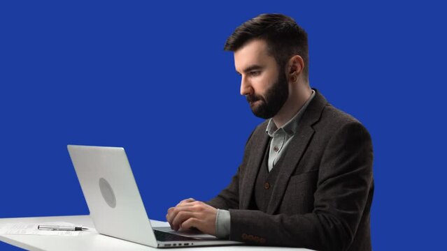 Confident business man working laptop desk at office chatting isolated blue screen chroma key