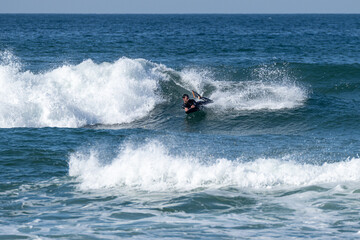 Bodyboarder surfing ocean wave