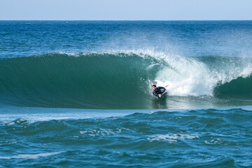 Bodyboarder surfing ocean wave