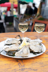 degustation plates with fresh oysters on farmer market in Parice, France