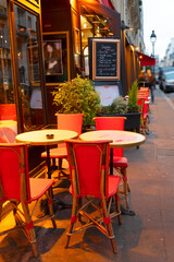 Fototapeta premium view of romantic Monmartre cafe tables at night close up, Paris, France
