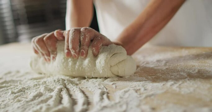 Animation of hand of asian female baker preparing sourdough for bread