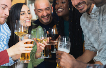 Group of diverse friends sharing beers and good times at home . A celebration of diversity, youth...