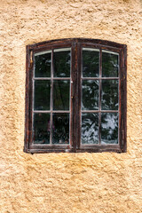An old wooden window with glass, a fragment of an old manor.