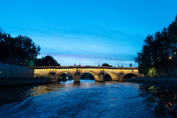 Fototapeta na wymiar bridge Pont Neuf and Seine river at illuminated at blue night, Paris, France