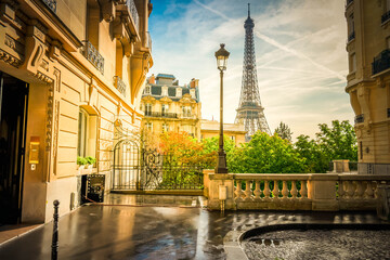cosy Paris street with view on the famous Eiffel Tower on a cloudy summer day, Paris France, retro...