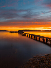 Beautiful view of jetty in the lake at sunrise time.