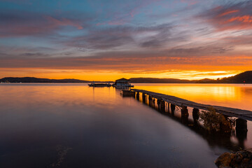 Fototapeta na wymiar Beautiful view of jetty in the lake at sunrise time.