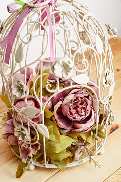 Decorative Cage With A Composition Of Artificial Flowers.