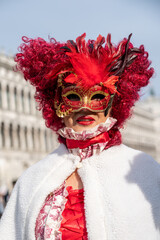Fototapeta na wymiar Costumed carnival participants and revellers mingle with tourists, visitors and locals as the carnival weekend gets into full swing in the streets and squares of Venice.