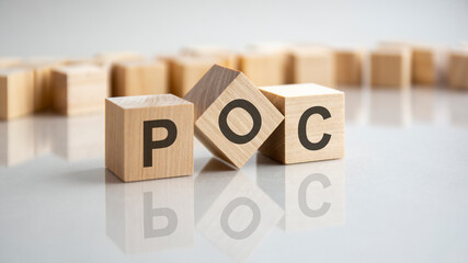 POC - Proof of Concept short form on wooden block
