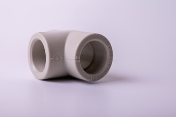 light PVC pipe tee connection for water isolated on light background close up.